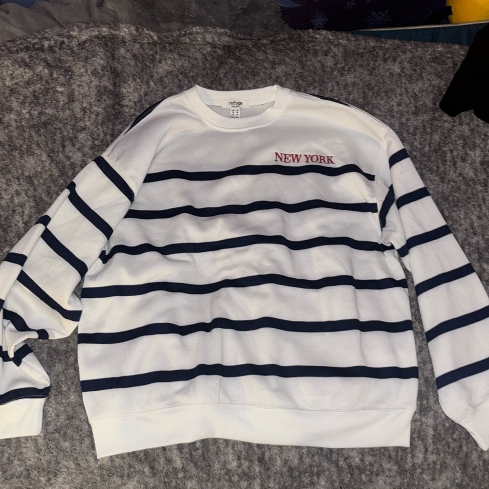 White with navy blue stripes crew neck, size medium, says New York on it.